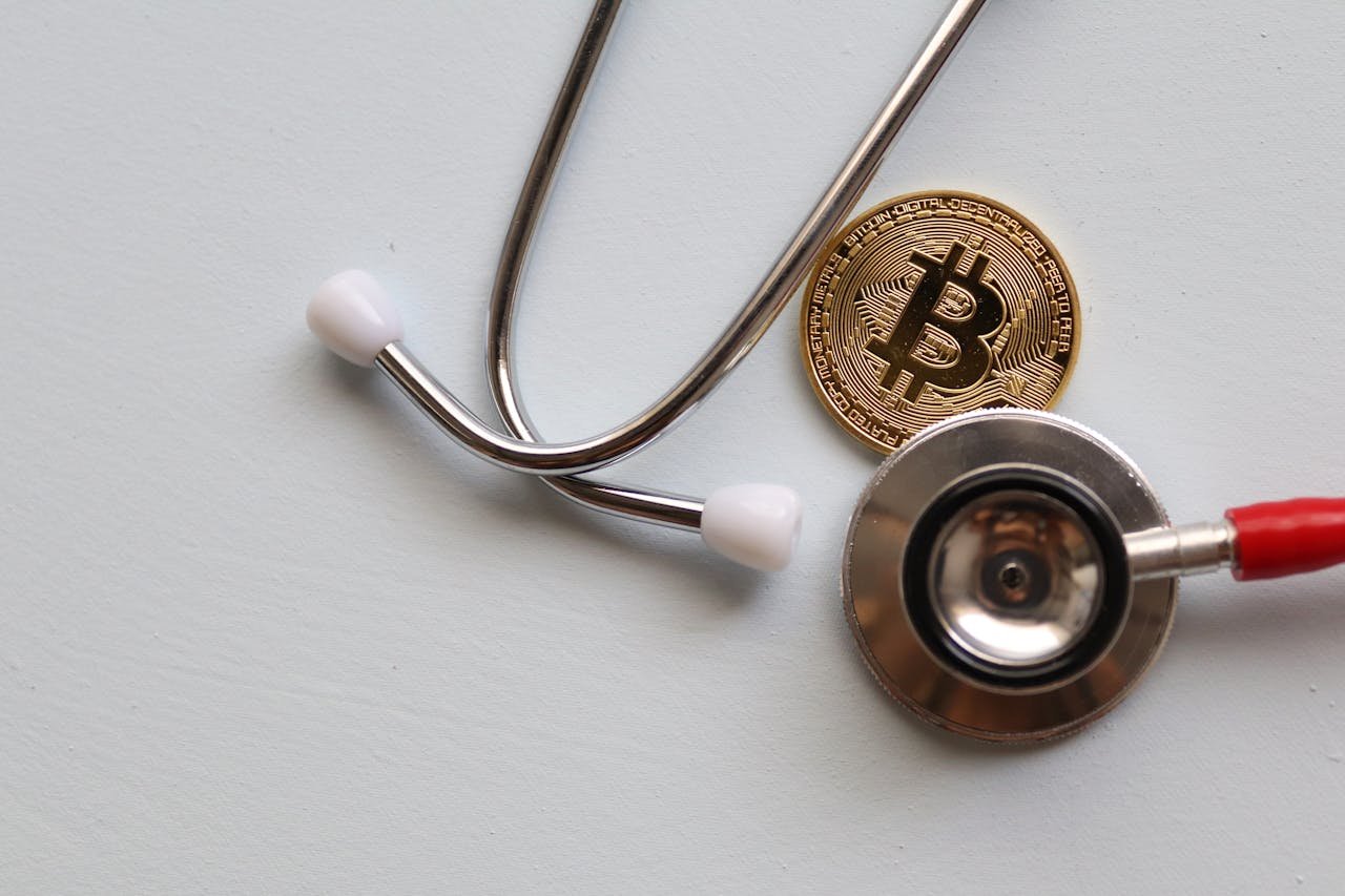 who-we-are A stethoscope with a Bitcoin coin symbolizing the intersection of healthcare and cryptocurrency.
